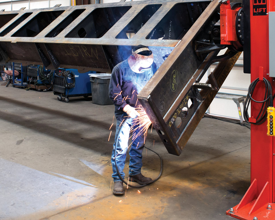 man welding a positioner